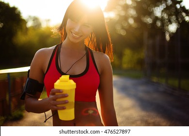 Healthy Fitness Girl With Protein Shake. Smile Sport Woman In The Sunny Day