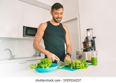 Healthy Fitness Sportsman Making Fresh Detox Homemade Celery Juice In Juicer Machine At Home. Healthy Food And Lifestyle. Detox Diet