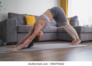 Healthy flexible girl home workout on yoga mat - Shutterstock ID 1904794642