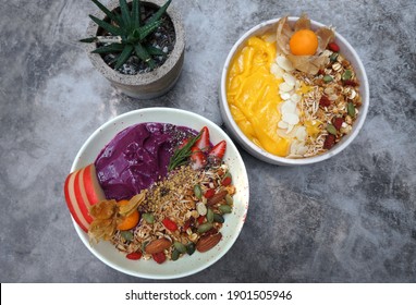 Healthy Food Acai And Mango Breakfast Superfoods Smoothie Bowl With Chia Seeds, Bee Pollen, Fresh Strawberry, Apple, Almond And Granola For Healthy Vegan 
