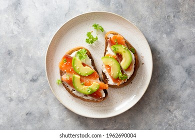 Healthy food, avocado and red fish salmon toast sandwich for breakfast or keto dieting, top view