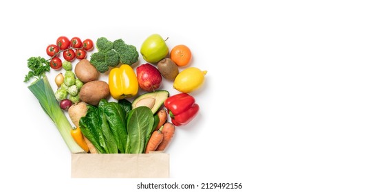 Healthy food background. Healthy food in paper bag vegetables and fruits on white. Food delivery, shopping food supermarket concept - Shutterstock ID 2129492156
