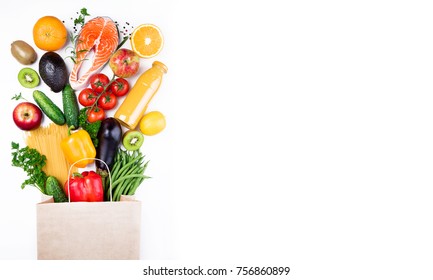 Healthy food background. Healthy food in paper bag fish, vegetables and fruits on white. Shopping food supermarket concept. Long format with copy space