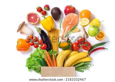 Healthy food background. Healthy food in paper bag fish, vegetables and fruits on white. Shopping food supermarket concept