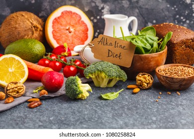 Healthy food background, trendy Alkaline diet products - fruits, vegetables, cereals, nuts, oil, dark background, copy space - Shutterstock ID 1080258824