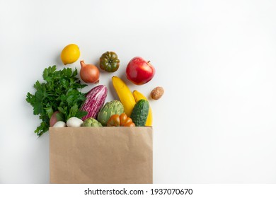 Healthy food background. Healthy vegan vegetarian food in paper bag vegetables and fruits on white, copy space. Shopping food supermarket and clean vegan eating concept. - Shutterstock ID 1937070670