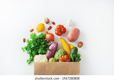 Healthy food background. Healthy vegan vegetarian food in paper bag vegetables and fruits on white, copy space. Shopping food supermarket and clean vegan eating concept. - Powered by Shutterstock