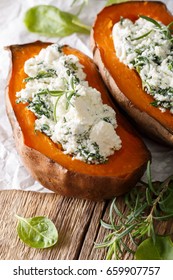 Healthy Food: Baked Sweet Potato With Spinach And Feta Close-up On The Table. Vertical
