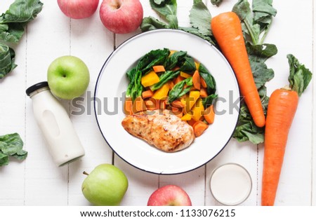healthy food chicken breast and vegetables White wood background