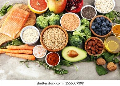 Healthy food clean eating selection: fish, fruit, vegetable, cereal, leaf vegetable on background - Shutterstock ID 1556309399
