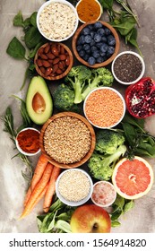 Healthy food clean eating selection: fruit, vegetable, seeds, superfood, cereals, leaf vegetable on background - Shutterstock ID 1564914820