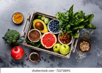 Healthy food clean eating selection in wooden box: fruit, vegetable, seeds, superfood, cereals, leaf vegetable on gray concrete background - Shutterstock ID 722718091