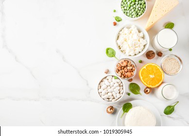 Healthy Food Concept. Set Of Food Rich In Calcium - Dairy And Vegan Ca Products, White Marble Background Top View Copy Space