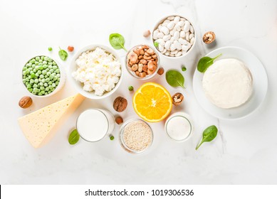 Healthy Food Concept. Set Of Food Rich In Calcium - Dairy And Vegan Ca Products, White Marble Background Top View Copy Space