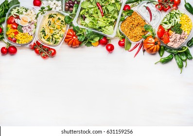 Healthy food concept. Variety of vegetables salad bowls in  plastic package on white wooden background, top view, border. Salad bar. Take away Diet lunch ideas