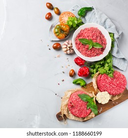 Healthy Food, Cooking Concept. Homemade Raw Organic Minced Beef Meat And Burger Steak Cutlet With Vegetables On A White Table. Copy Space Background, Top View Flat Lay