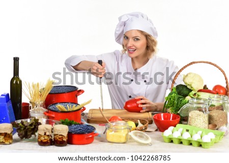 Healthy food cooking, vegetarian concept. Young female cook preparing delicious food in kitchen. Diet, vegetarian, healthy organic food cooking. Isolated on white backgroung. Woman in cook uniform.