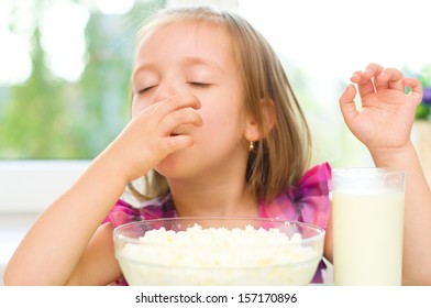 Healthy Food. Cute Little Girl Is Eating Cottage Cheese, Curd With Milk