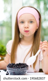 Healthy Food. Cute Little Girl Eating Blueberries