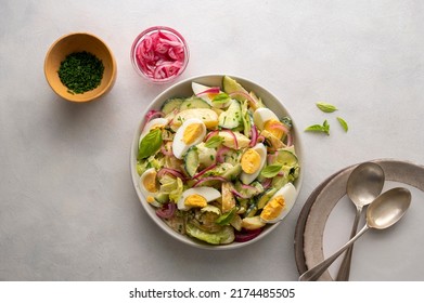 Healthy food. Delicios potato salad with eggs, cucumbers, cabbage and red pickled onions. Delicious healthy summer salad - Powered by Shutterstock