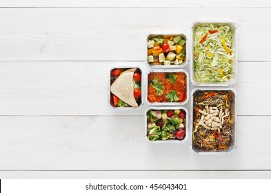 Healthy Food Delivery, Daily Ration. Take Away Of Natural Organic Low Carb Diet. Fitness Nutrition In Foil Boxes. Top View, Flat Lay With Copy Space At White Wood