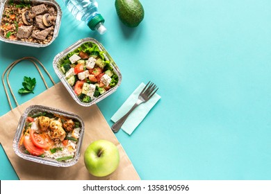 Healthy food delivery. Take away of organic daily meal on blue, copy space. Clean eating concept, healthy food, fitness nutrition take away in boxes, top view.