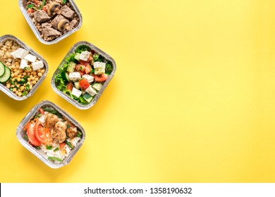 Healthy Food Delivery. Take Away Of Organic Daily Meal On Yellow, Copy Space. Clean Eating Concept, Healthy Food, Fitness Nutrition Take Away In Foil Boxes, Top View.