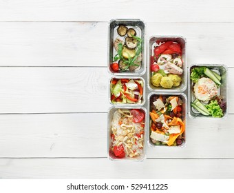 Healthy Food Delivery. Take Away Of Natural Organic Fitness Nutrition For Diet. Daily Meals In Foil Boxes With Copy Space At White Wood. Top View, Flat Lay