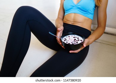 Healthy Food, Diet, Lifestyle And Sport. Young Fit Woman Having Light Snack After Workout. Eating Smoothie Bowl