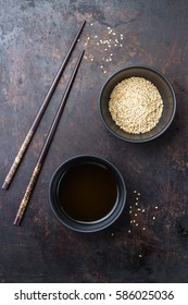 Healthy Food And Drink Concept. Sesame Oil And Seeds On A Chinese Japanese Table With Chop Sticks. Top Bird View, Flat Lay Overhead