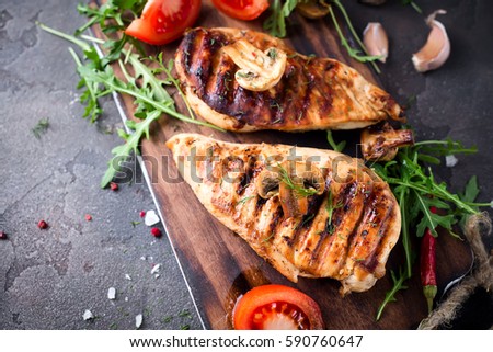 healthy food - grilled chicken with vegetables on a wooden board