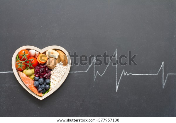Healthy food in heart and cardiograph on\
blackboard medical abstract\
concept