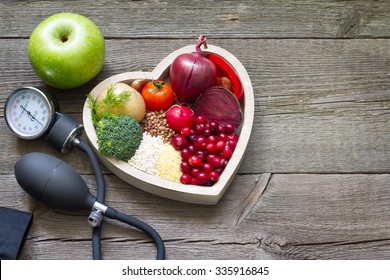 Healthy food in heart and cholesterol diet concept on vintage boards - Shutterstock ID 335916845