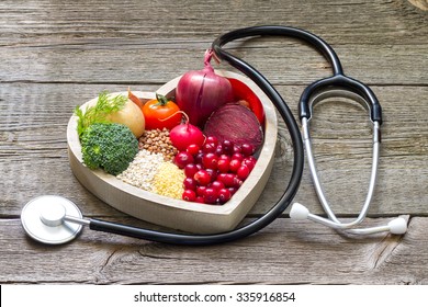 Healthy food in heart and cholesterol diet concept on vintage boards - Shutterstock ID 335916854