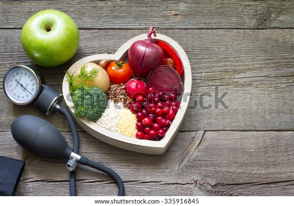 Healthy food in heart and cholesterol diet concept
on vintage boards