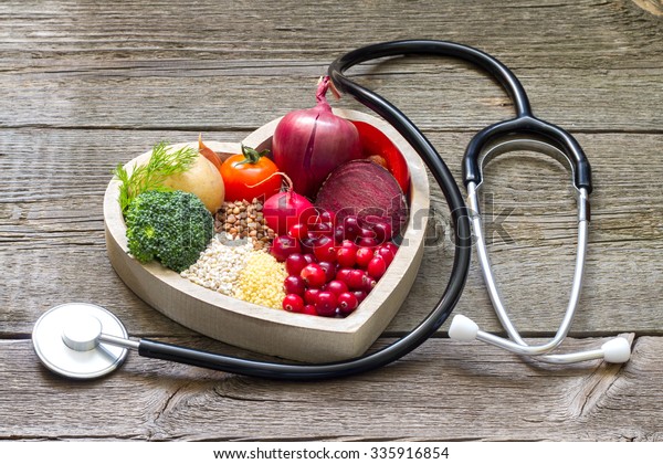 Healthy food in heart and cholesterol diet concept\
on vintage boards