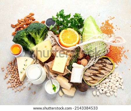 Healthy food high in calcium on light background. Dairy products, vegetables and superfoods. Ca products. Top view, flat lay