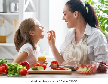 Healthy food at home. Happy family in the kitchen. Mother and child daughter are preparing the vegetables. - Shutterstock ID 1178673640