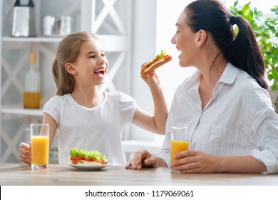 Healthy food at home. Happy family in the kitchen. Mother and child daughter are having breakfast. - Shutterstock ID 1179069061
