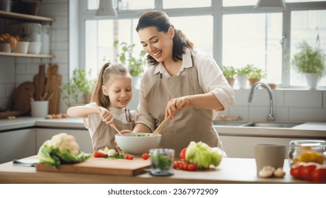 Healthy food at home. Happy family in the kitchen. Mother and child daughter are preparing proper meal. - Powered by Shutterstock