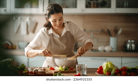 Healthy food at home. Woman is preparing the proper meal in the kitchen. - Powered by Shutterstock