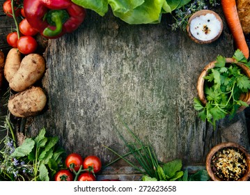 Healthy food ingredients background. Vegetables, herbs and spices. Organic vegetables on wood