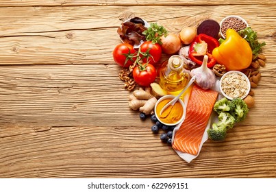 Healthy Food Ingredients In Shape Of Love Heart On Wooden Table With Copy Space