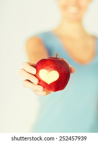 Healthy Food And Lifestyle - Woman Hand Holding Red Apple With Heart Shape