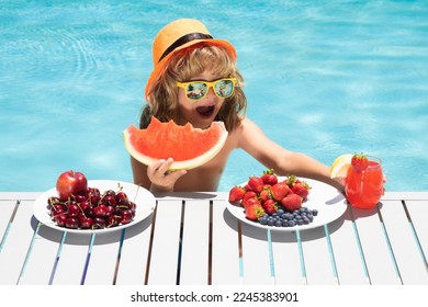 Healthy food. Outdoor leisure activity with kids by swimming pool. Summertime. Child eating fruits near swimming pool during summer holidays. Kids eat fruit. Healthy fruits for children. - Shutterstock ID 2245383901