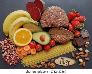 Healthy Food Rich In Fiber. Fiber High Food. Natural Sources Of Fiber: Almond, Strawberry, Banana, Dark Chocolate, Cherry Tomato, Whole Grain Bread, Spaghetti, Beetroot, Carrot, Bean, Orange, Avocado.