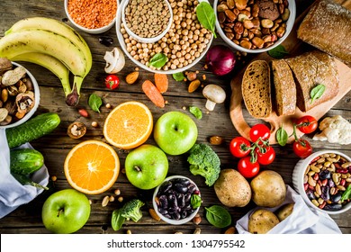 Healthy food. Selection of good carbohydrate sources, high fiber rich food. Low glycemic index diet. Fresh vegetables, fruits, cereals, legumes, nuts, greens. Wooden background copy space - Shutterstock ID 1304795542