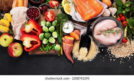Healthy Food Selection On Dark Background. Detox And Clean Diet Concept. Foods High In Vitamins, Minerals And Antioxidants. Anti Age Foods. Top View. Panorama With Copy Space.