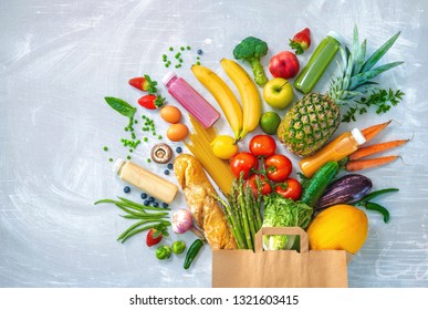Healthy food selection. Shopping bag with groceries full of fresh vegetables and fruits - Shutterstock ID 1321603415