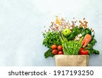 Healthy food shopping or delivery concept, top down view on a variety of fresh produce in a paper bag, composition with copy space for a text 